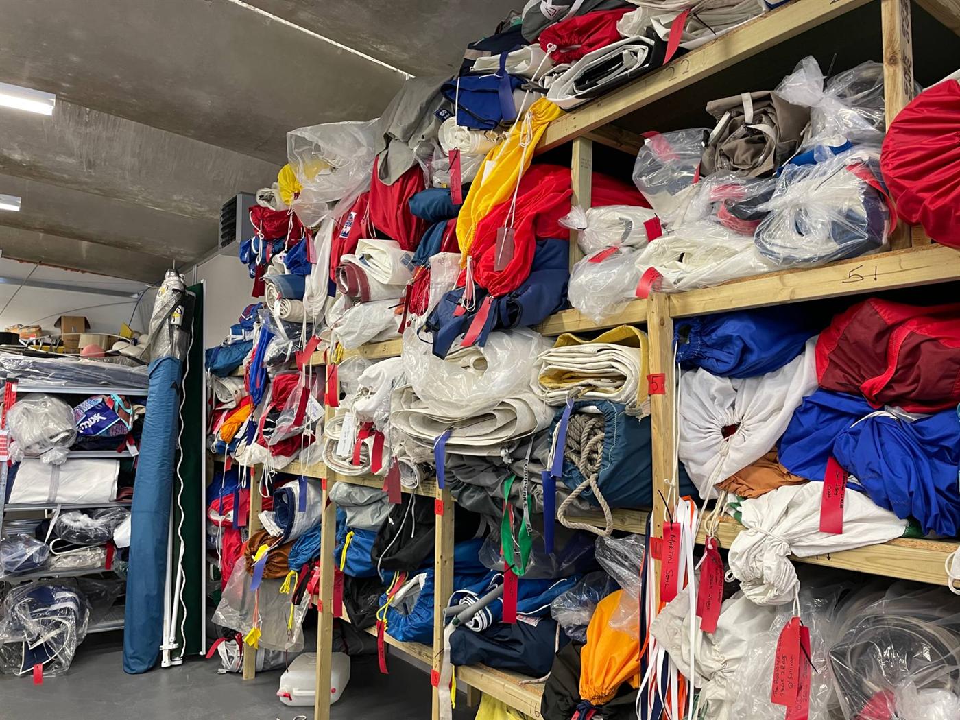 Customers’ sails bagged, tagged and stored on racks at the Boatshed Sailmakers loft in Pwllheli