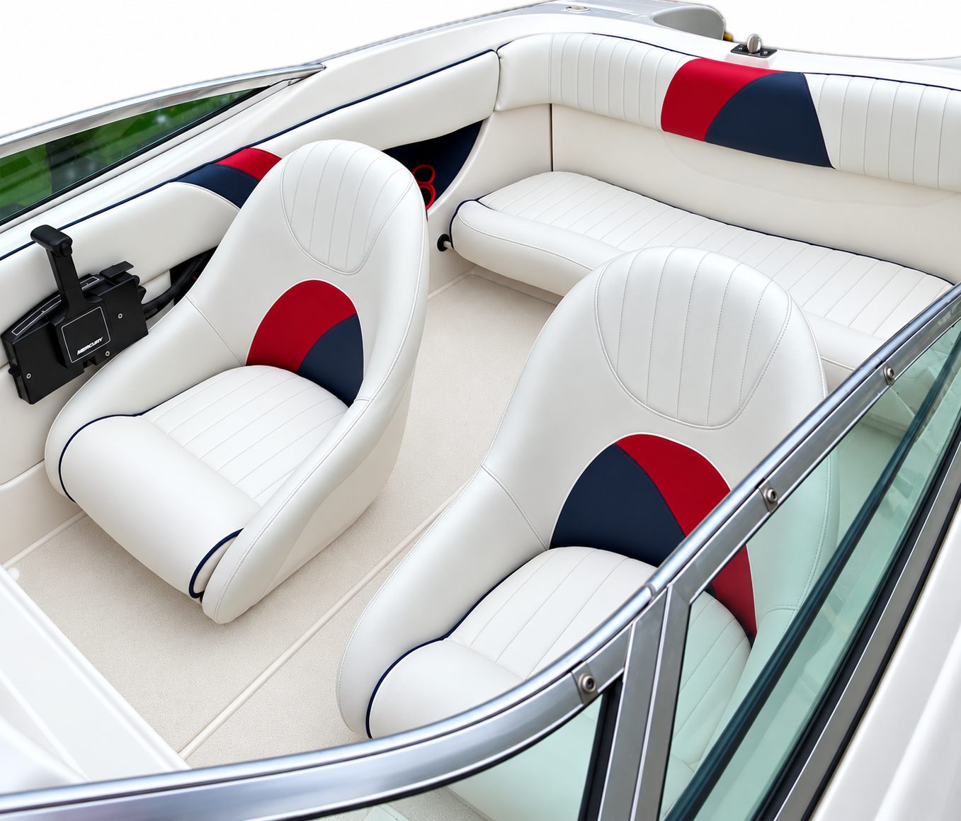 White marine vinyl boat seats with red and navy panels after reupholstery