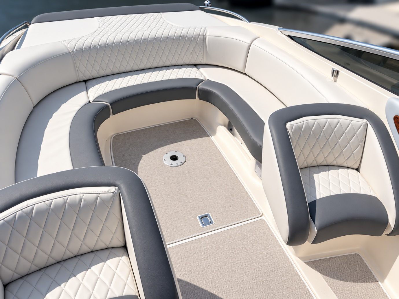 Cream and grey diamond-stitched marine upholstery on a motorboat bow seating area