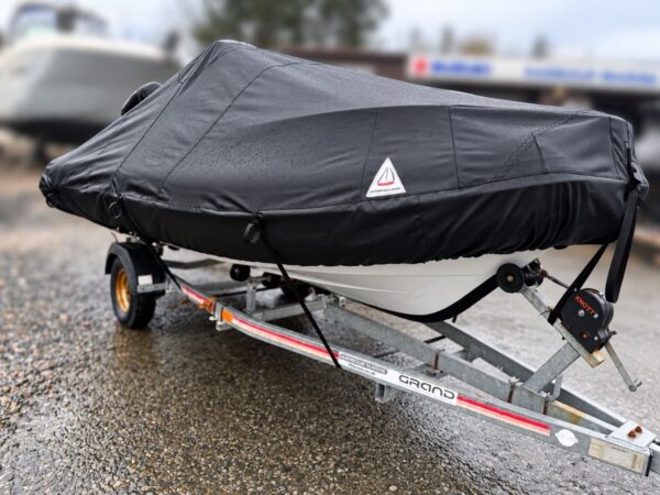 Grand 420 RIB on its trailer with a black full winter cover fitted over the console and hooked to the hull