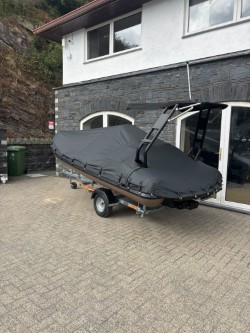Highfield 420 Velox RIB on its trailer with a grey full winter cover fitted over the console