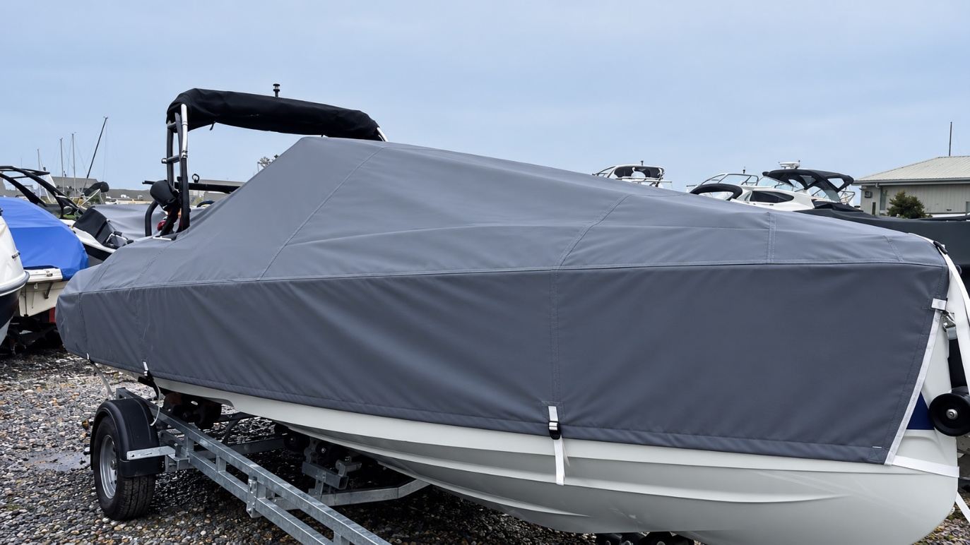 Saxdor 200 Full Winter Cover (Older Model) 1 Older Saxdor 200 on its trailer with a grey full winter cover fitted over the console and around the arch, strapped to the hull